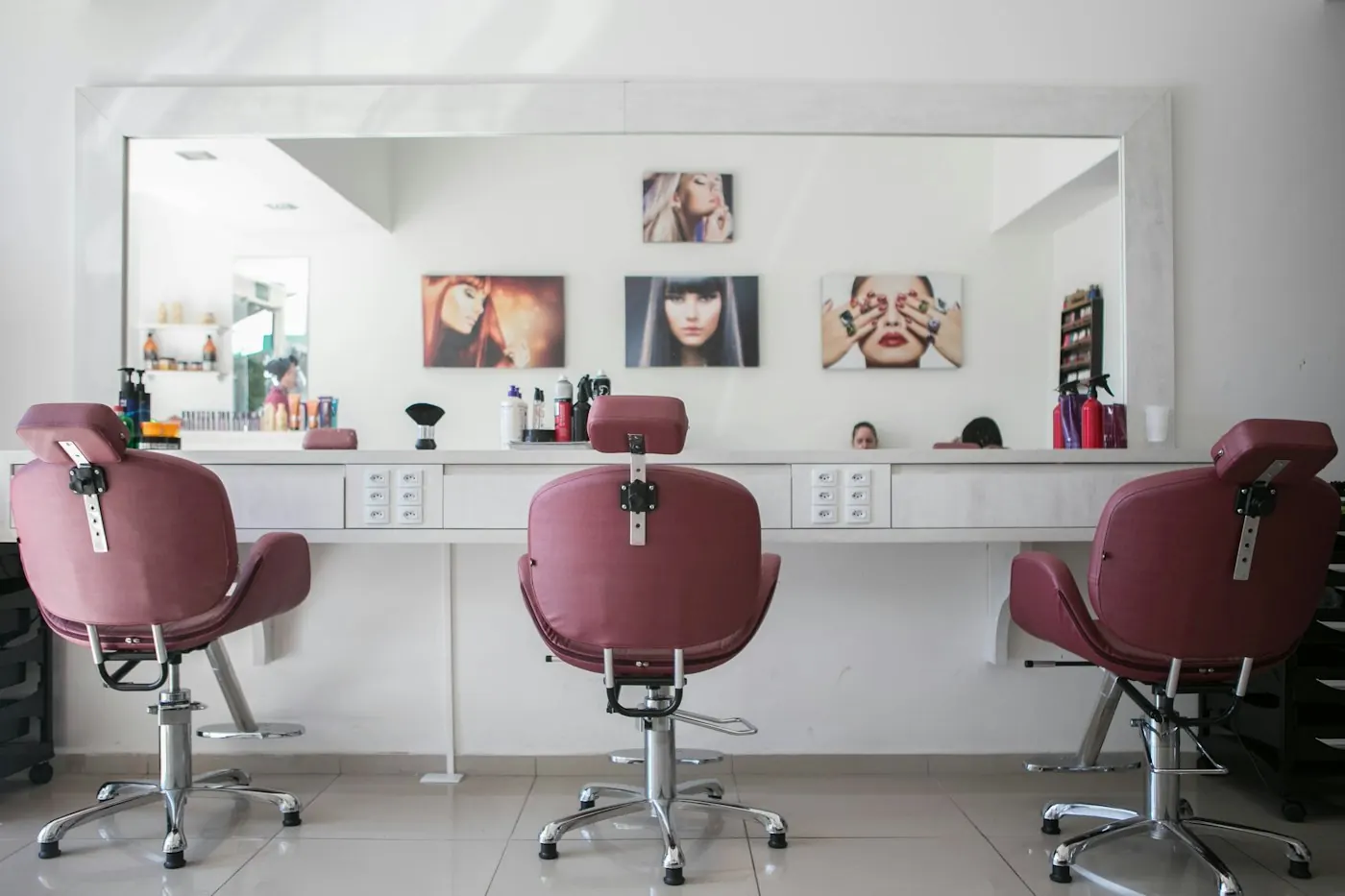 A bright, classic salon with styling chairs and a long mirror